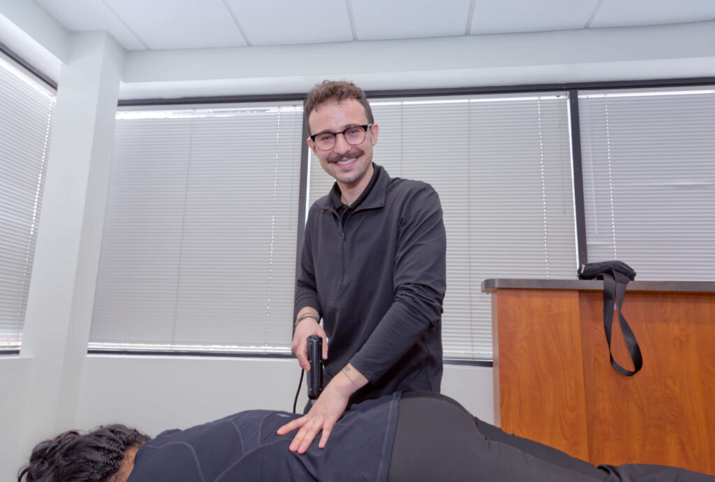 Dr. Connor Reed giving patient sciatica pain treatment