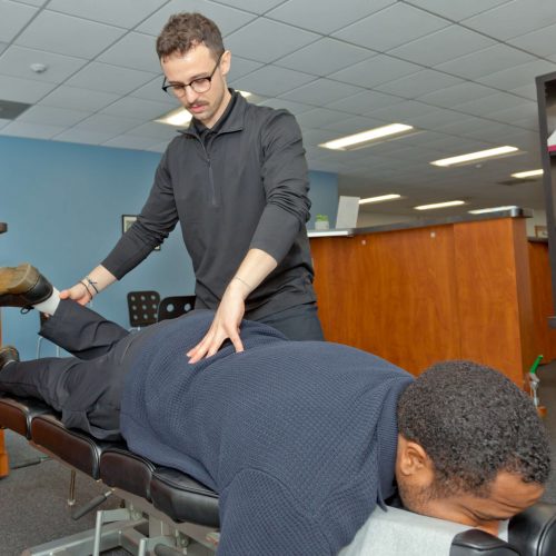 Dr. Connor Reed attend patients back pain with gonstead technique