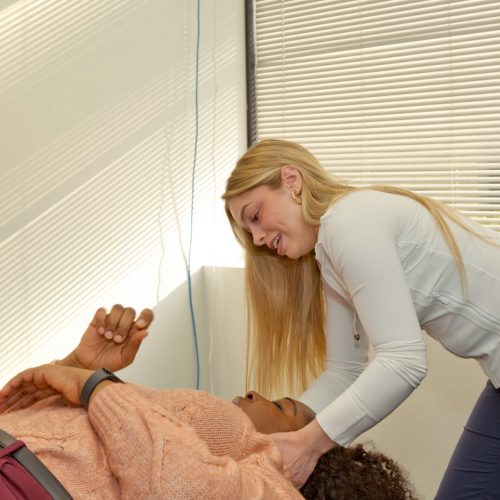 Dr. Marissa Jenney giving patient intersegmental traction treatment