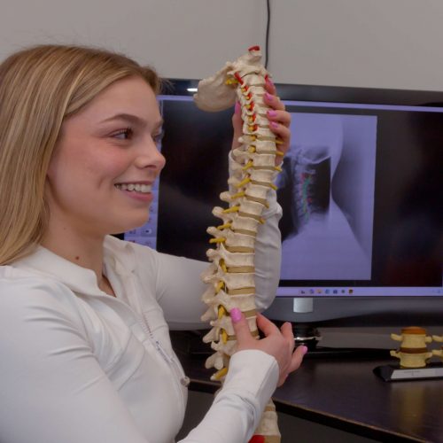 Dr. Marissa Jenney holding a spine model